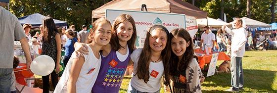 Smiling Girls at a No Kid Hungry Bake Sale